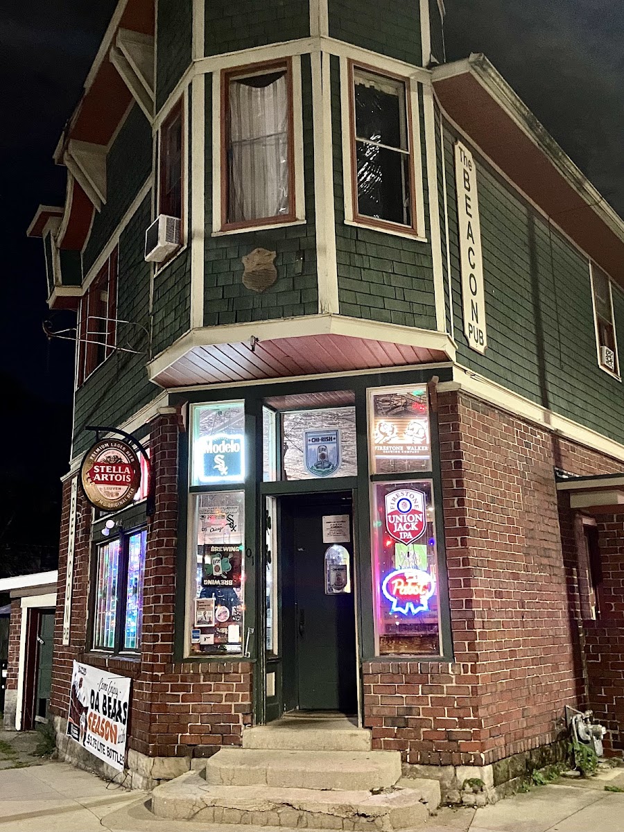 The Beacon Pub on the corner of Circle Ave at night, neon signs glowing